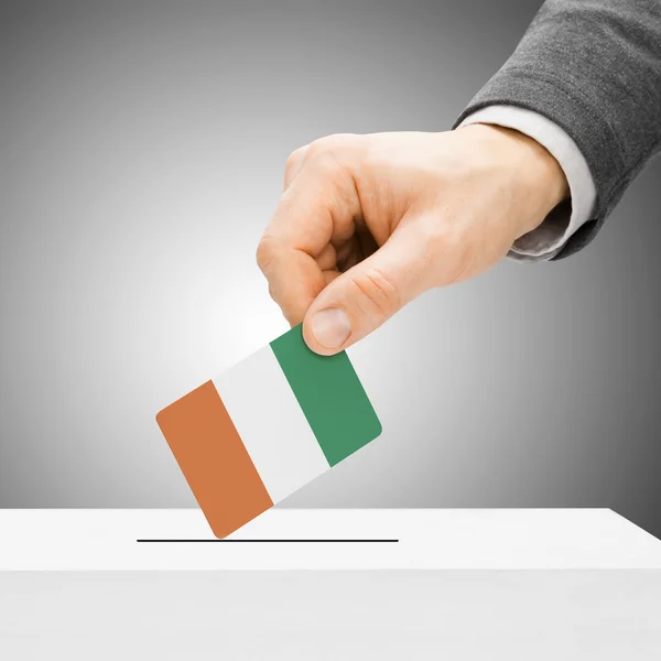 Voting concept - Male inserting flag into ballot box - Cote d'Iv — Stock Photo, Image