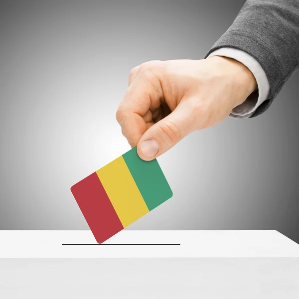 Voting concept - Male inserting flag into ballot box - Guinea — Stock Photo, Image