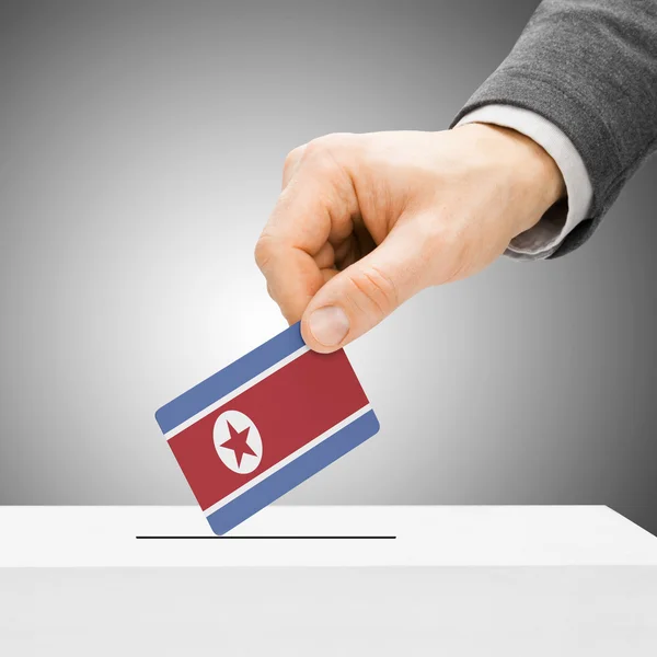 Voting concept - Male inserting flag into ballot box - North Kor — Stock Photo, Image