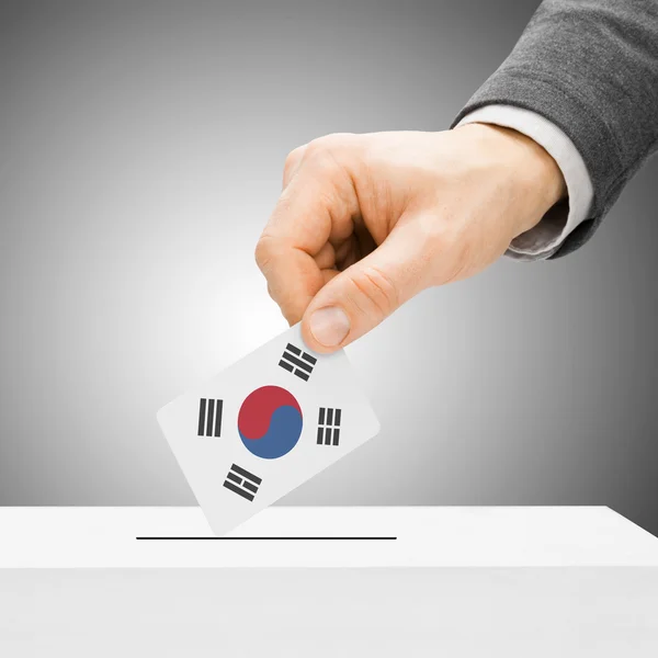 Voting concept - Male inserting flag into ballot box - South Kor — Stock Photo, Image