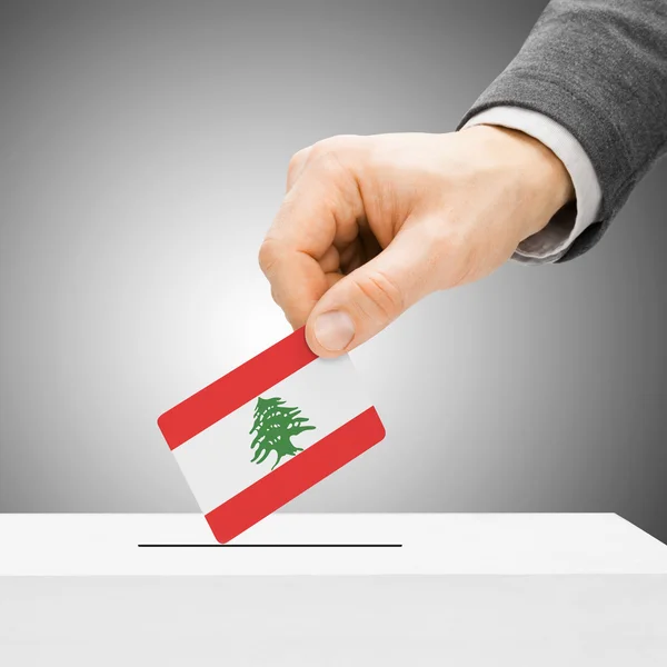 Voting concept - Male inserting flag into ballot box - Lebanon — Stock Photo, Image