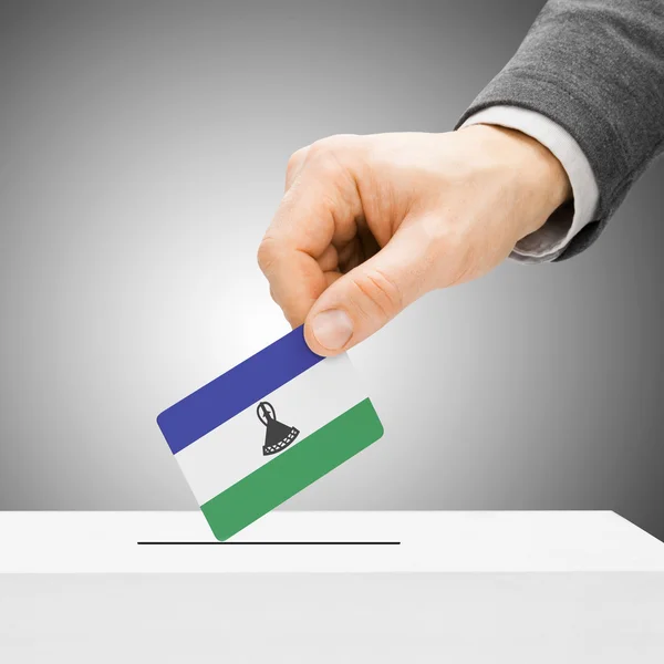 Voting concept - Male inserting flag into ballot box - Lesotho — Stock Photo, Image