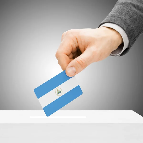 Voting concept - Male inserting flag into ballot box - Nicaragua — Stock Photo, Image