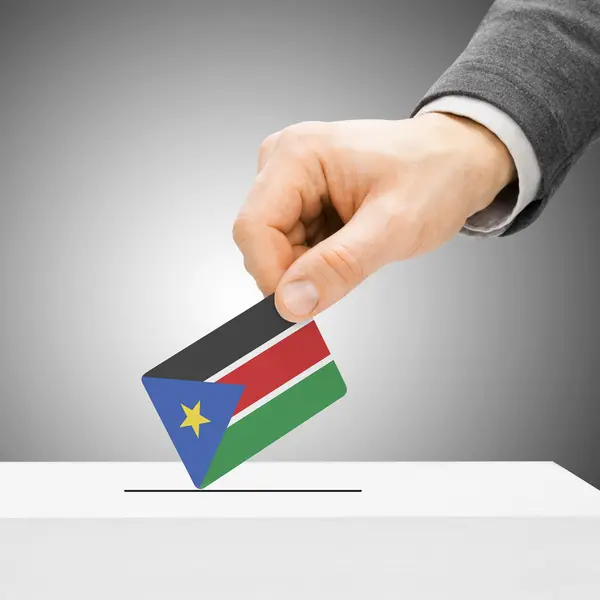 Voting concept - Male inserting flag into ballot box - South Sud — Stock Photo, Image