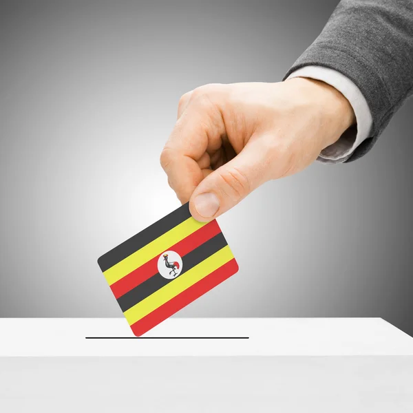 Voting concept - Male inserting flag into ballot box - Uganda — Stock Photo, Image