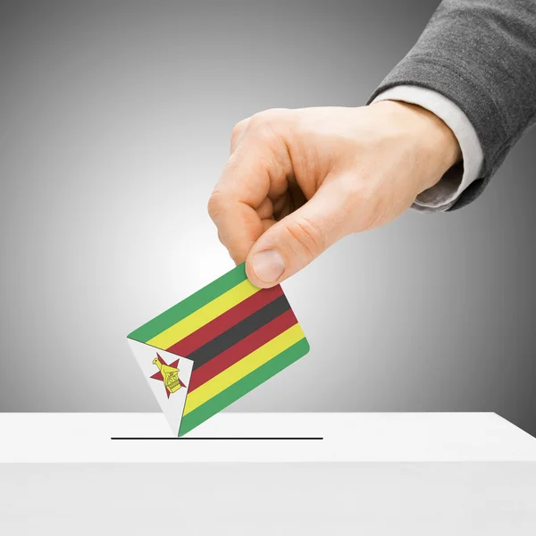 Voting concept - Male inserting flag into ballot box - Zimbabwe — Stock Photo, Image