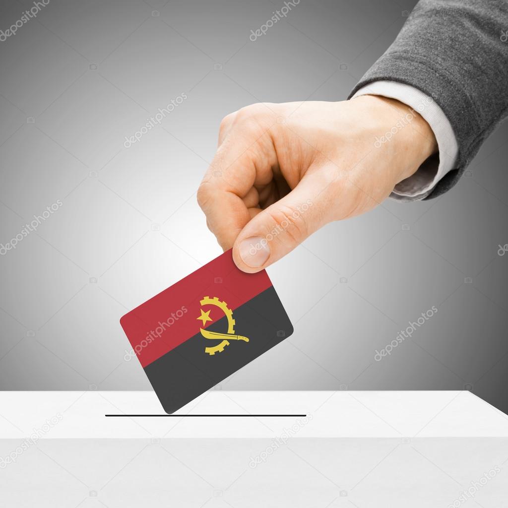 Voting concept - Male inserting flag into ballot box - Angola