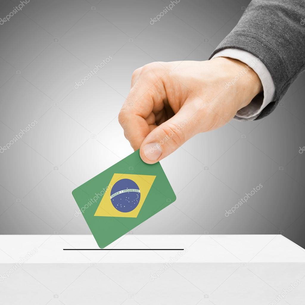 Voting concept - Male inserting flag into ballot box - Brazil