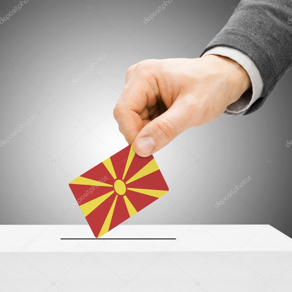 Voting concept - Male inserting flag into ballot box - Republic 