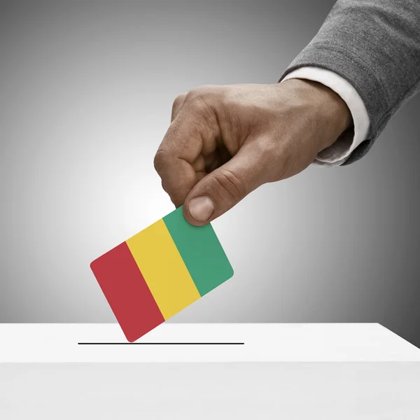 Black male holding flag. Voting concept - Guinea — Stock Photo, Image
