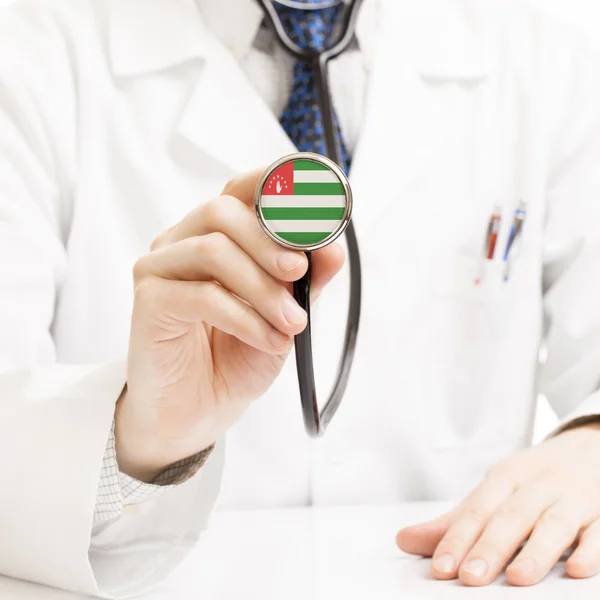 Doctor holding stethoscope with flag series - Abkhazia — Stock Photo, Image