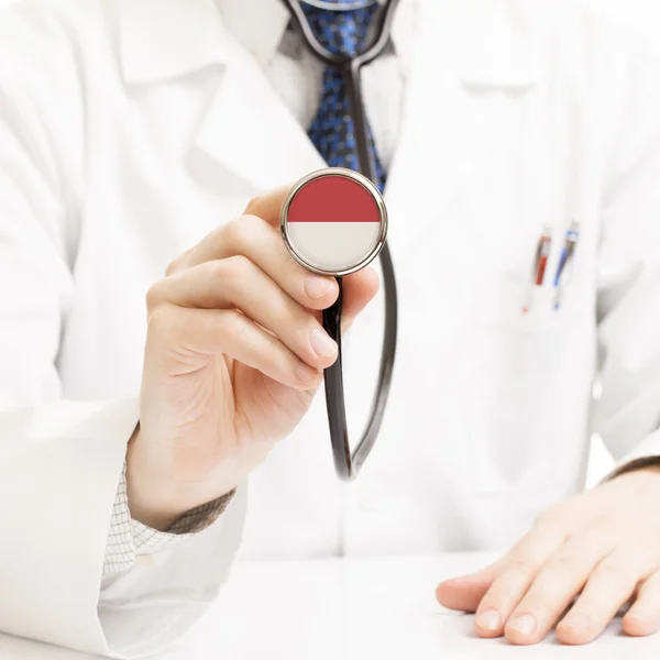 Lekarz stetoskop gospodarstwa z flaga serii - Monako — Zdjęcie stockowe