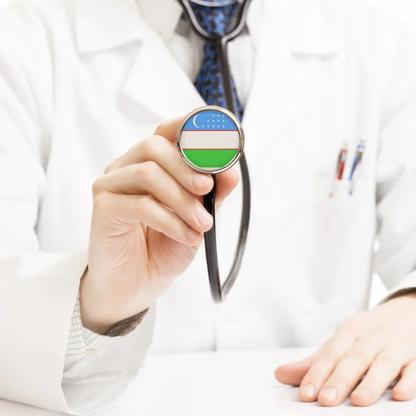 Doctor holding stethoscope with flag series - Uzbekistan — Stock Photo, Image