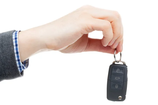 Male hand giving car keys - studio shot over white background — Stock Photo, Image