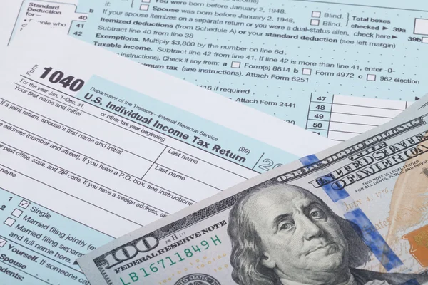 US 1040 Tax Form and dollars - studio shot — Stock Photo, Image