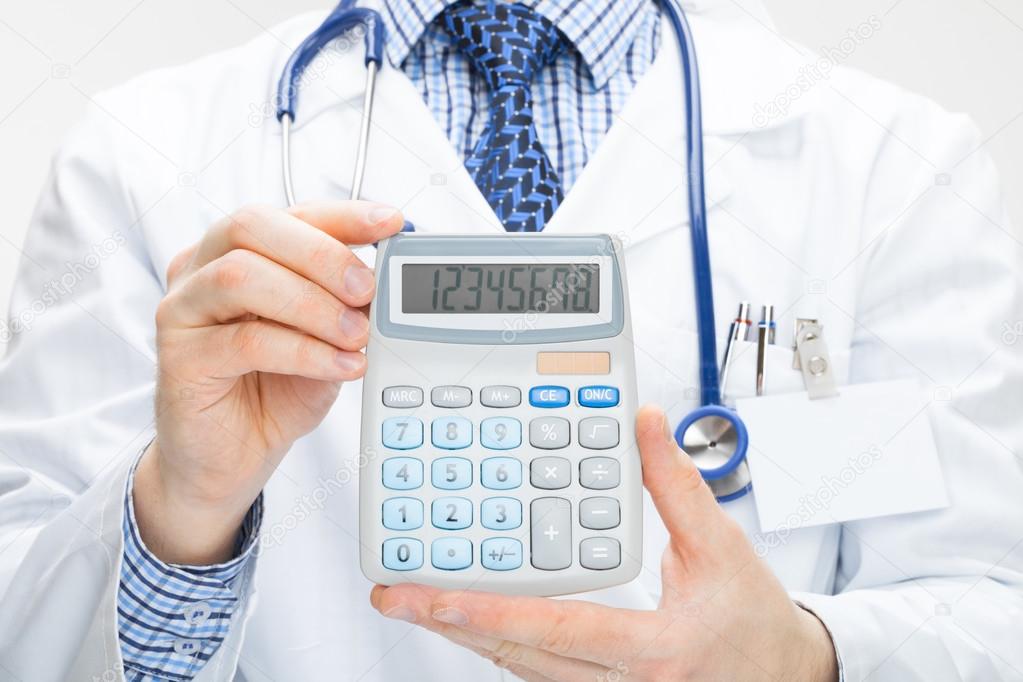 Doctor holding calculator in hands - health care concept - studio shot