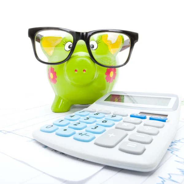 Market charts with piggy bank and calculator over it - studio sh — Stock Photo, Image