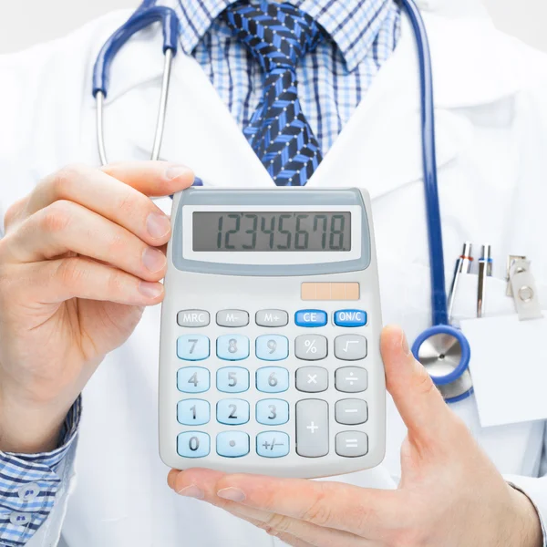 Doctor holding calculator in hands - health care concept - studi — Stock Photo, Image