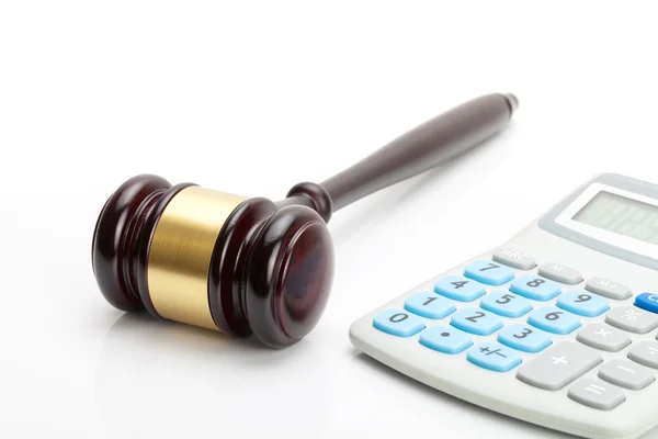 Wooden judge's gavel and calculator next to it — Stock Photo, Image