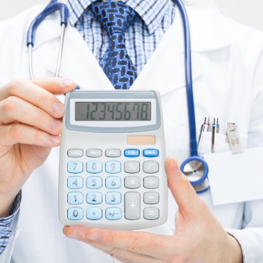 Male doctor holding calculator in hands - health care concept clipart