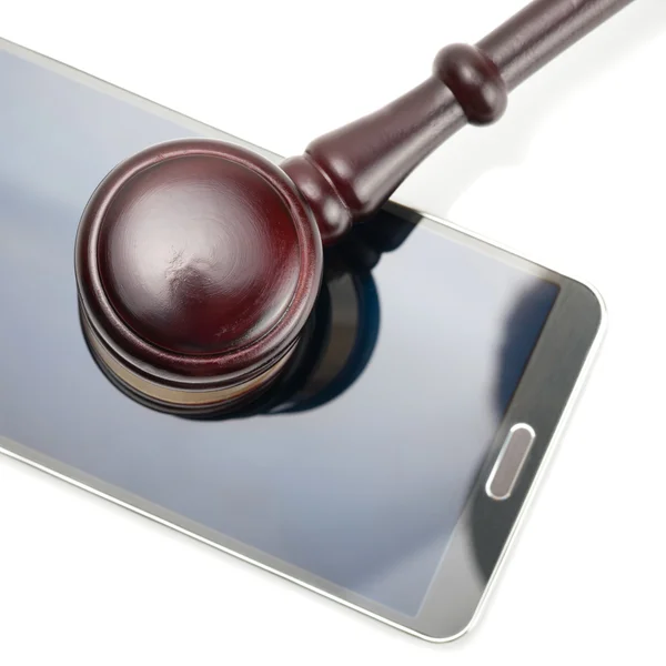 Smartphone under judge gavel - close up studio shot on white — Stock Photo, Image