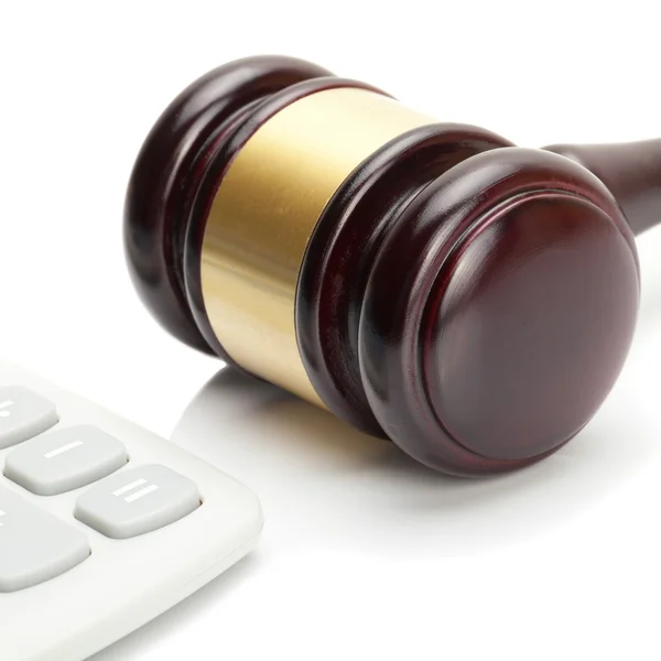 Wooden judge's gavel and calculator right next to it - close up shot — Stock Photo, Image