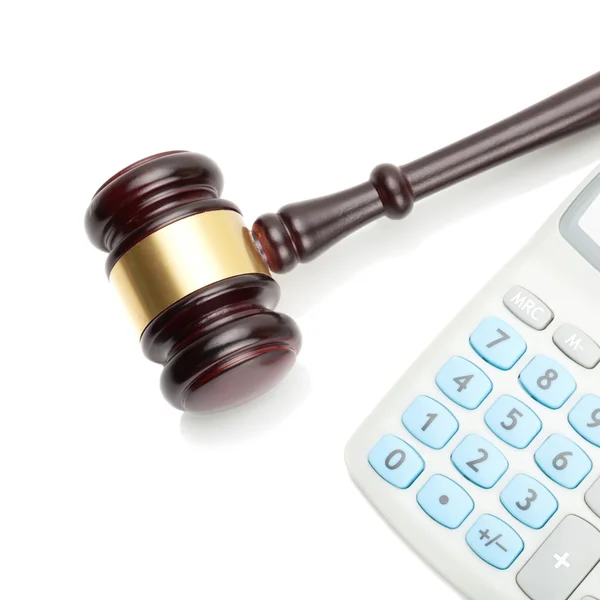 Wooden judge's gavel and neat calculator next to it - close up shot — Stock Photo, Image