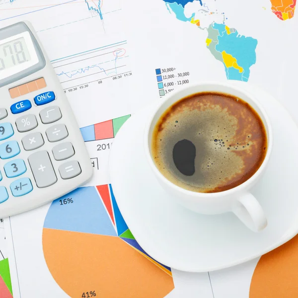 Coffee cup and calculator over financial documents - close up studio shot — Stock Photo, Image