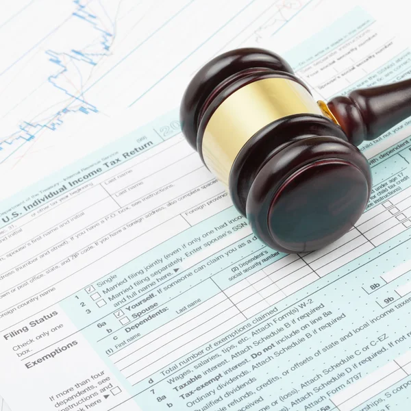 Wooden judge's gavel over 1040 US Tax form - close up shot — Stock Photo, Image