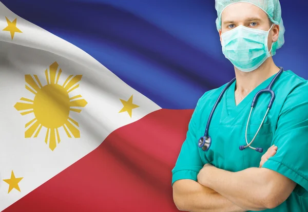 Хирург с национальным флагом на фоне серии - Филиппины — стоковое фото