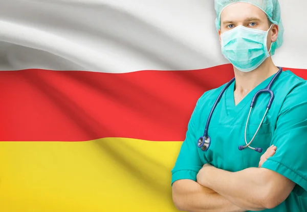 Chirurg s státní vlajka v pozadí řady - Jižní Osetie — Stock fotografie