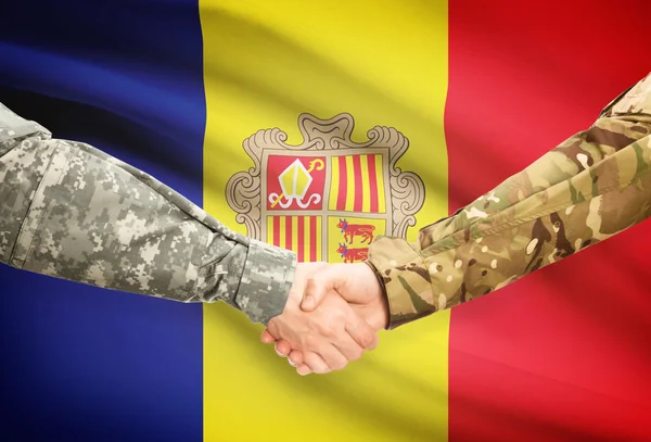 Men in uniform shaking hands with flag on background - Andorra — Stock Photo, Image