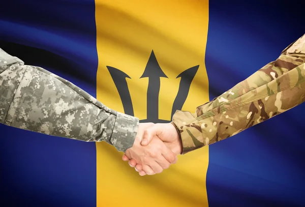 Men in uniform shaking hands with flag on background - Barbados — kuvapankkivalokuva