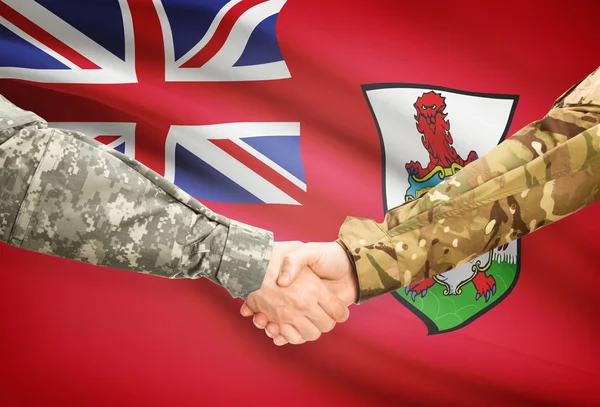 Men in uniform shaking hands with flag on background - Bermuda — Stock Photo, Image
