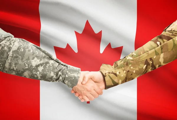 Men in uniform shaking hands with flag on background - Canada — Stock Photo, Image