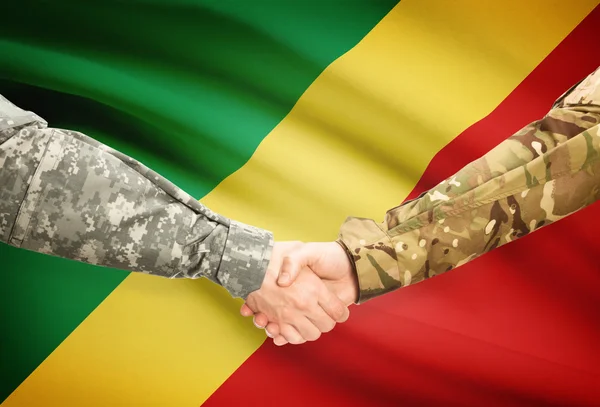 Men in uniform shaking hands with flag on background - Congo-Brazzaville — Stock Photo, Image