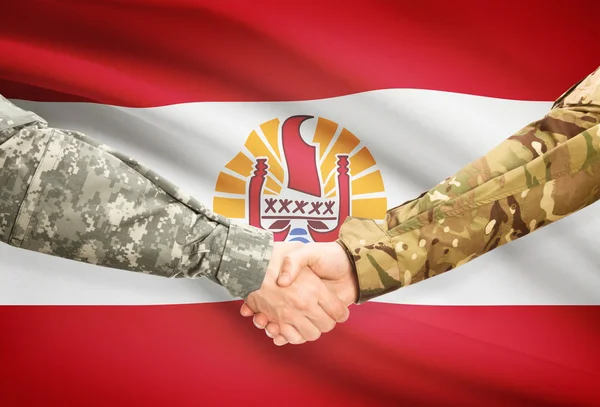 Men in uniform shaking hands with flag on background - French Polynesia — Stock Photo, Image