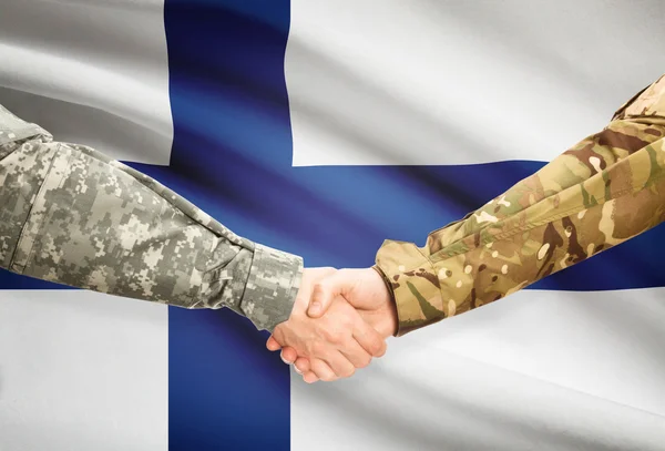 Men in uniform shaking hands with flag on background - Finland — Stock Photo, Image