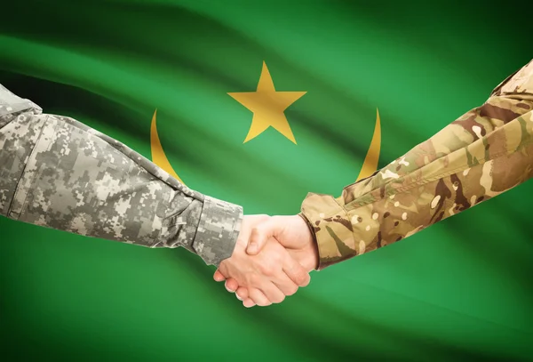 Men in uniform shaking hands with flag on background - Mauritania — Stock Photo, Image