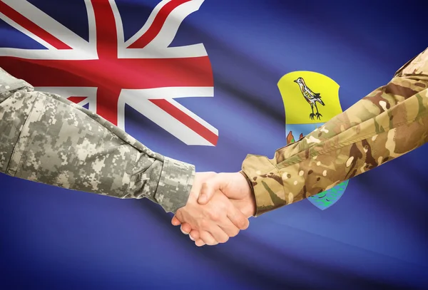 Men in uniform shaking hands with flag on background - Saint Helena — Stock Photo, Image