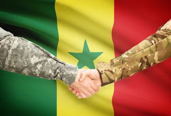 Men in uniform shaking hands with flag on background - Senegal — Stock Photo, Image