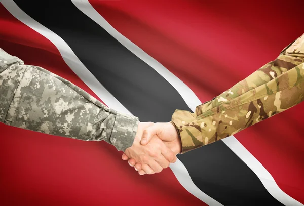 Men in uniform shaking hands with flag on background - Trinidad and Tobago — Stock Photo, Image