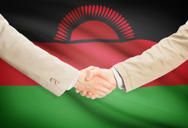 Arka plan - Malavi bayrağı ile işadamları el sıkışma