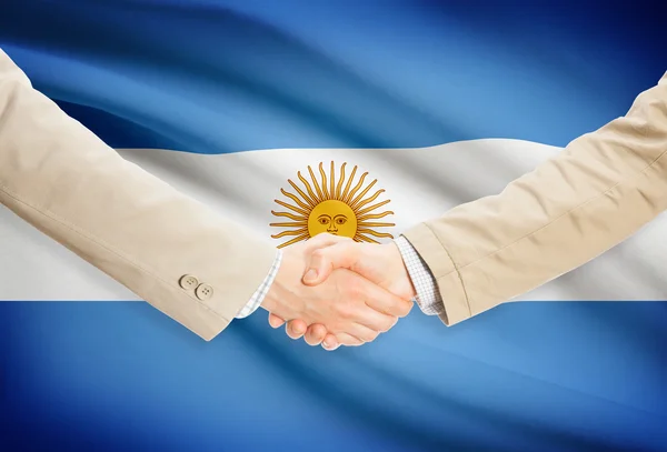 Poignée d'hommes d'affaires avec le drapeau sur fond - Argentine — Photo