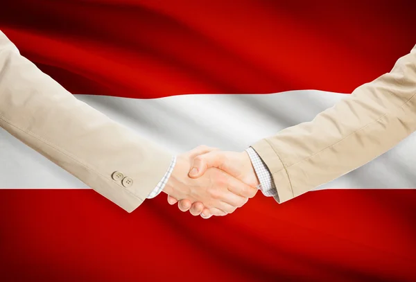 Businessmen handshake with flag on background - Austria — Stock Photo, Image