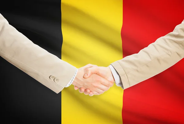 Businessmen handshake with flag on background - Belgium — Stock Photo, Image