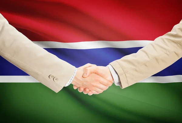 Businessmen handshake with flag on background - Gambia — Stock Photo, Image