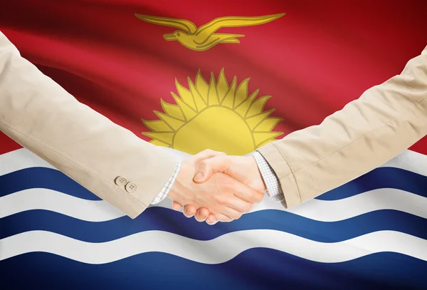 Businessmen handshake with flag on background - Kiribati — Stock Photo, Image