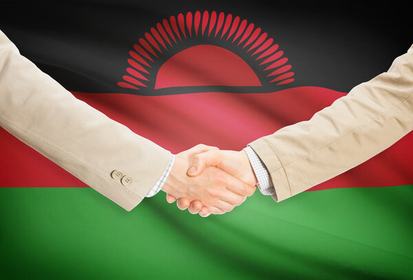Businessmen handshake with flag on background - Malawi