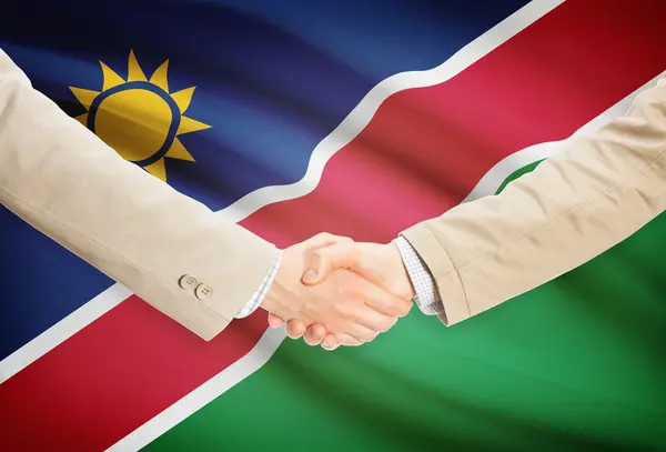 Apretón de manos de empresarios con bandera sobre fondo - Namibia — Foto de Stock